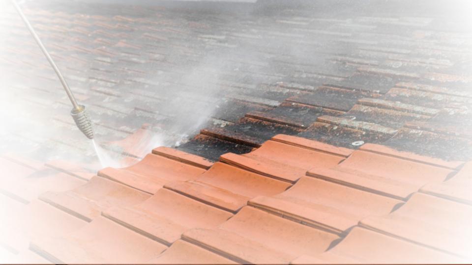 roof pressure wash cleaning to remove black stains from lichen growth on clay tiles